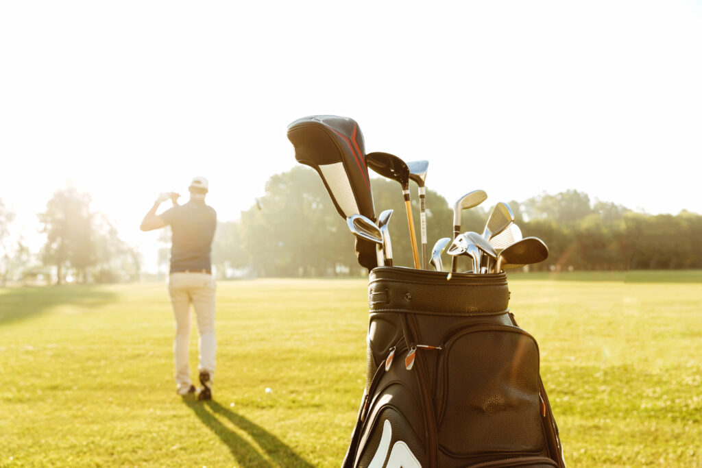 back view male golfer swinging golf club x