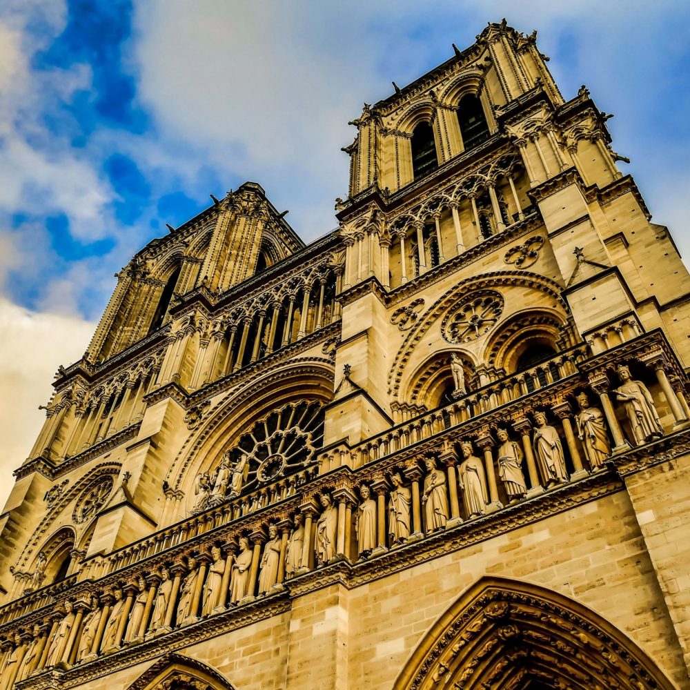 A low angle shot of the Square Jean XXIII captured under the beautiful cloudy sky in Paris, France
