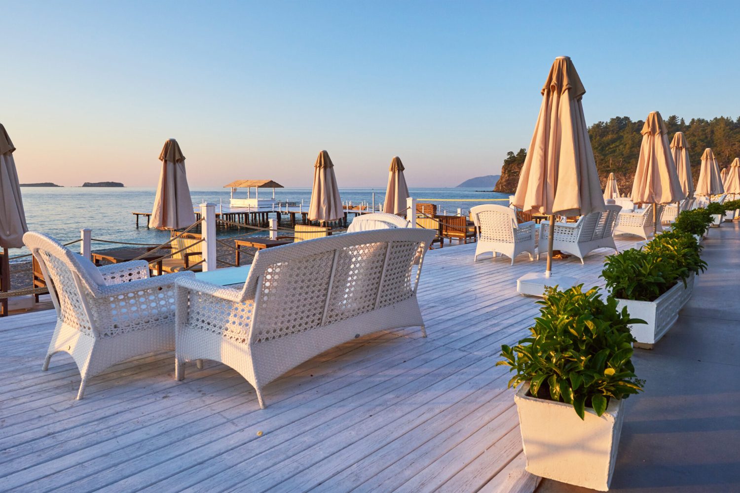 Scenic view of sandy beach on the beach with sun beds and umbrellas open against the sea and mountains. Hotel. Resort. Tekirova-Kemer